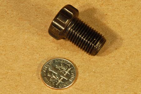 The 1/2-20 squib holding bolt itself, with a dime for scale.