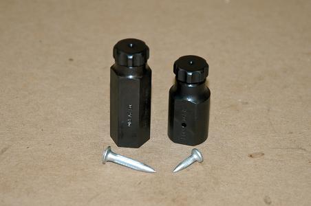 Large on the left, Small on the right.  Both poppers use a D60-3 or T12-3 squib to operate.  The Large Glass Breaker or Popper is used for breaking tempered glass.  The body of the breaker is turned from 3/4 inch (19mm) cold rolled steel hex bar stock and uses a large Hilti nail to notch and break tempered glass.  On critical shots, such as a stunt person hurling themselves through a aheet of tempered glass, we always use two poppers.